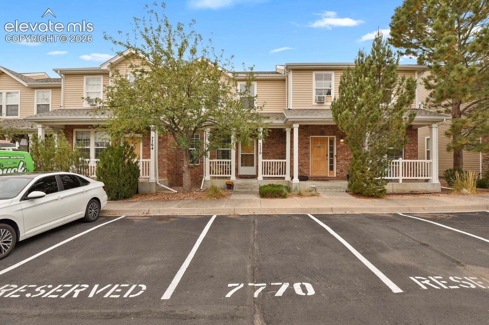 Front of the home with designated parking and porch
