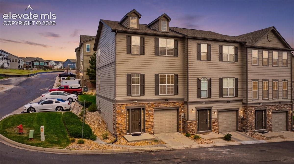 Multi-level townhome architecture featuring durable siding and stone-look accents