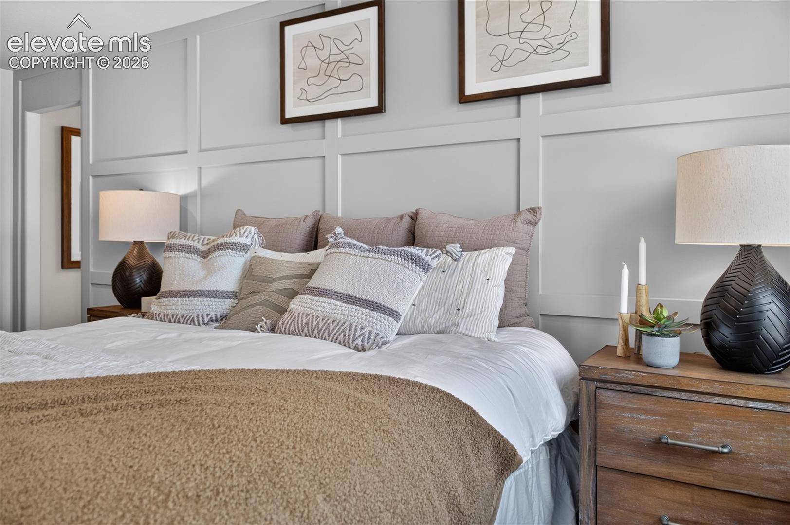 Accent wall featuring grid-pattern millwork and neutral-toned paint finish