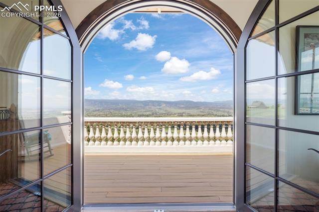 Crow's nest arched French doors open to the private balcony with panoramic Front Range views.