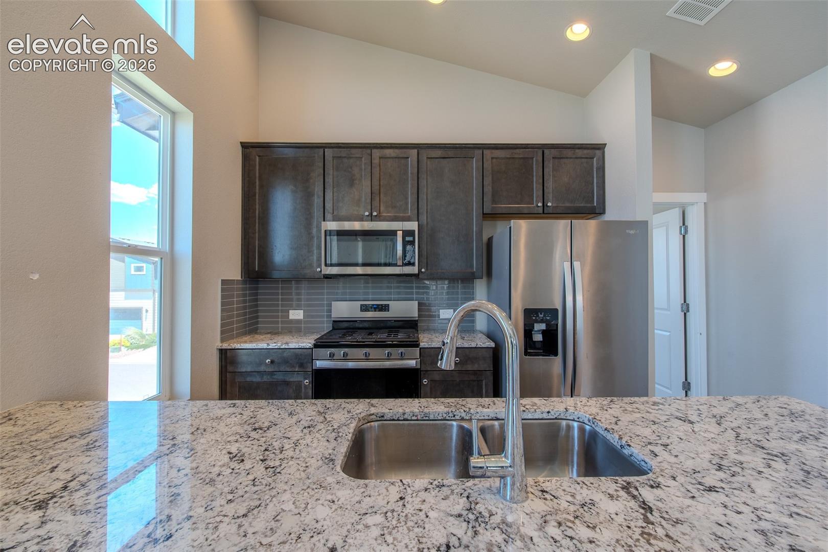 Granite breakfast bar with double stainless steel sink.