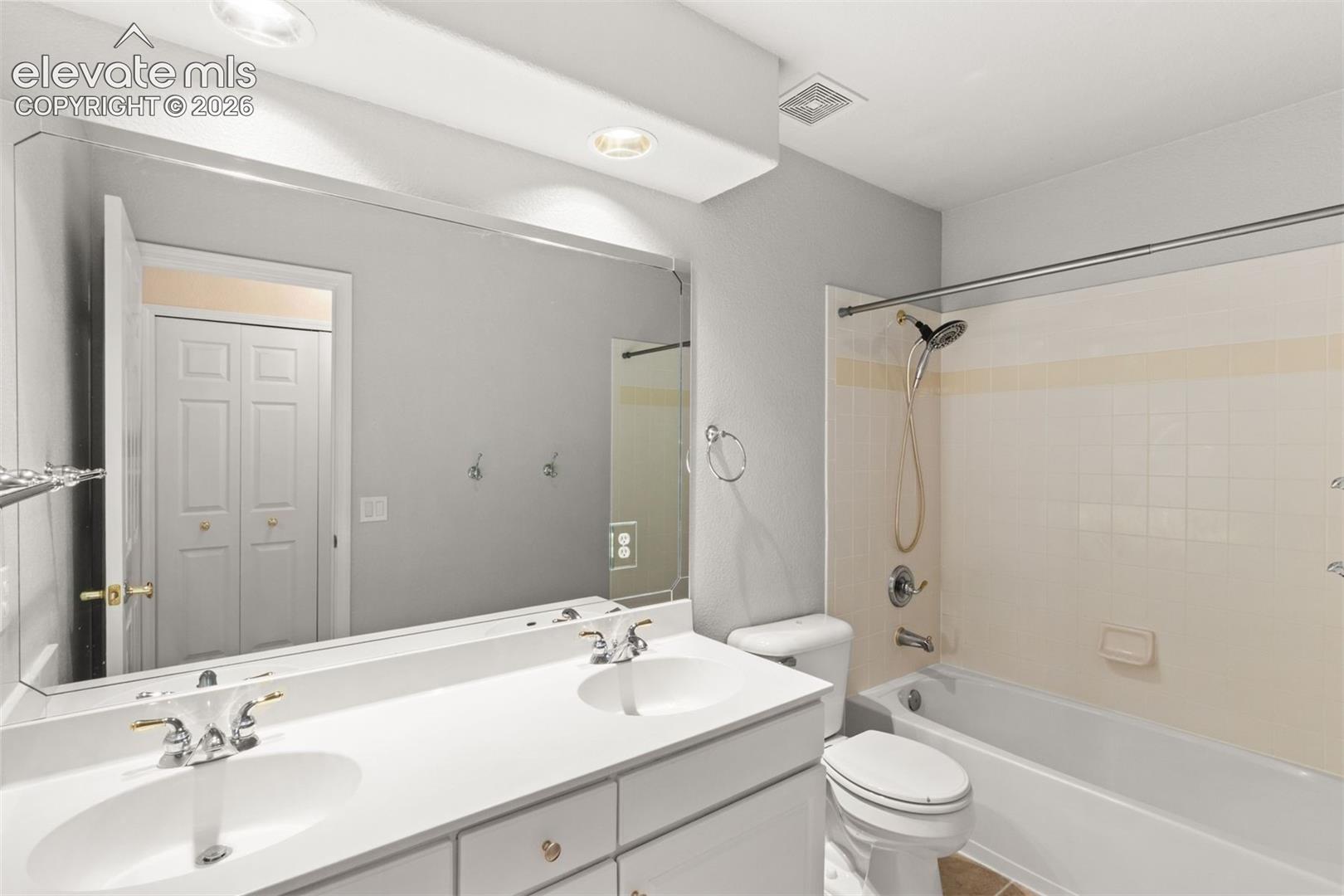 Upstairs full bathroom with dual sink vanities