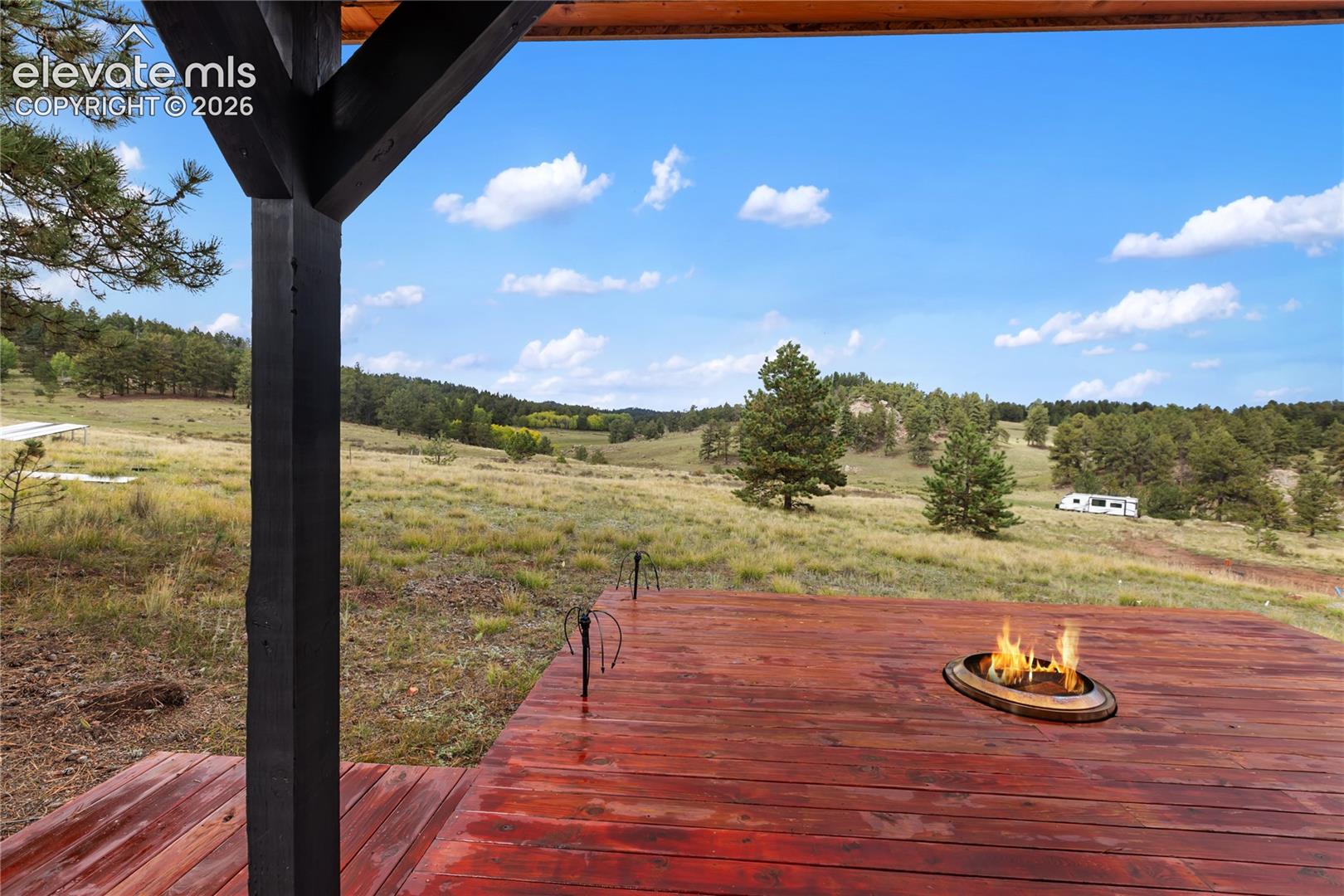 Outbuilding with deck and fire pit.