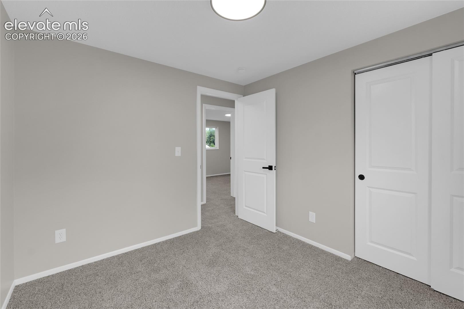 Neutral-toned walls complement plush carpeting