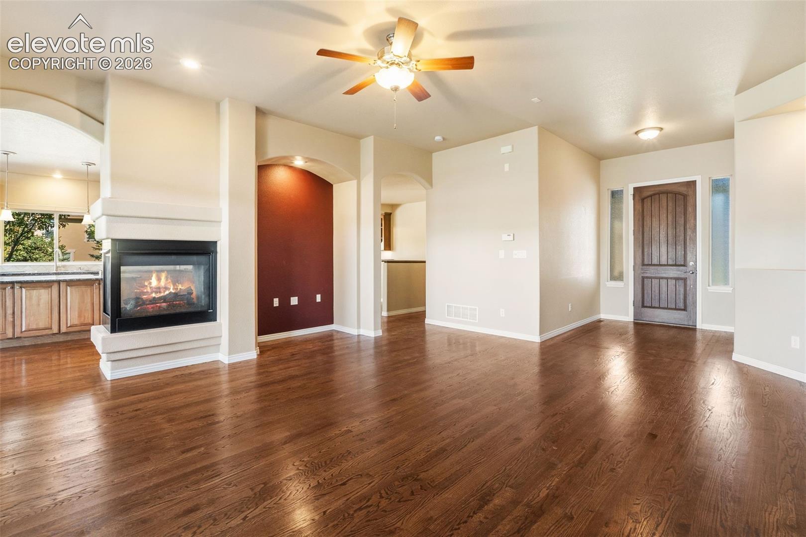 ADDITIONAL VIEW OF LIVING ROOM WITH FIREPLACE & CEILING FAN