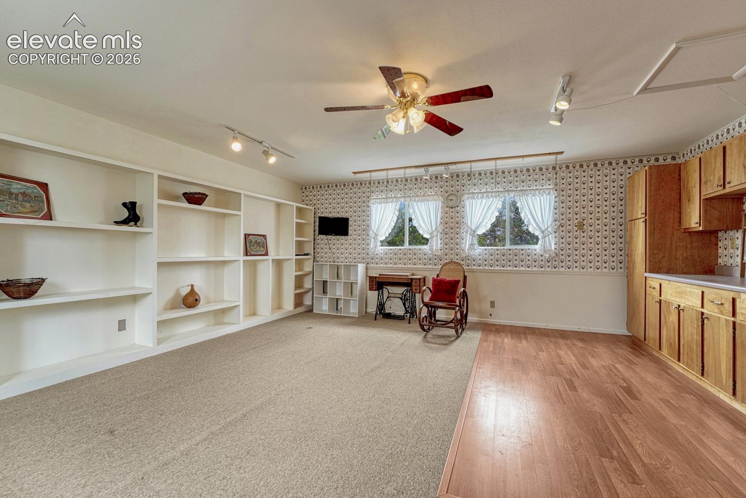 Versatile space - currently used as a craft room with lighted ceiling fan, built-in shelves and cabinetry.