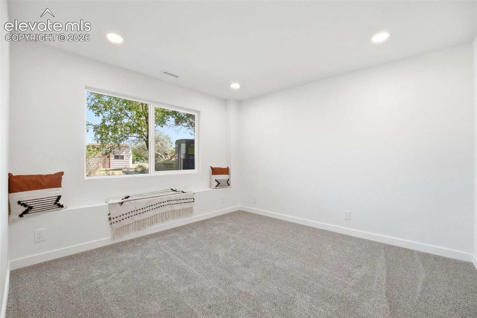Expansive room featuring a large window with a built-in window seat