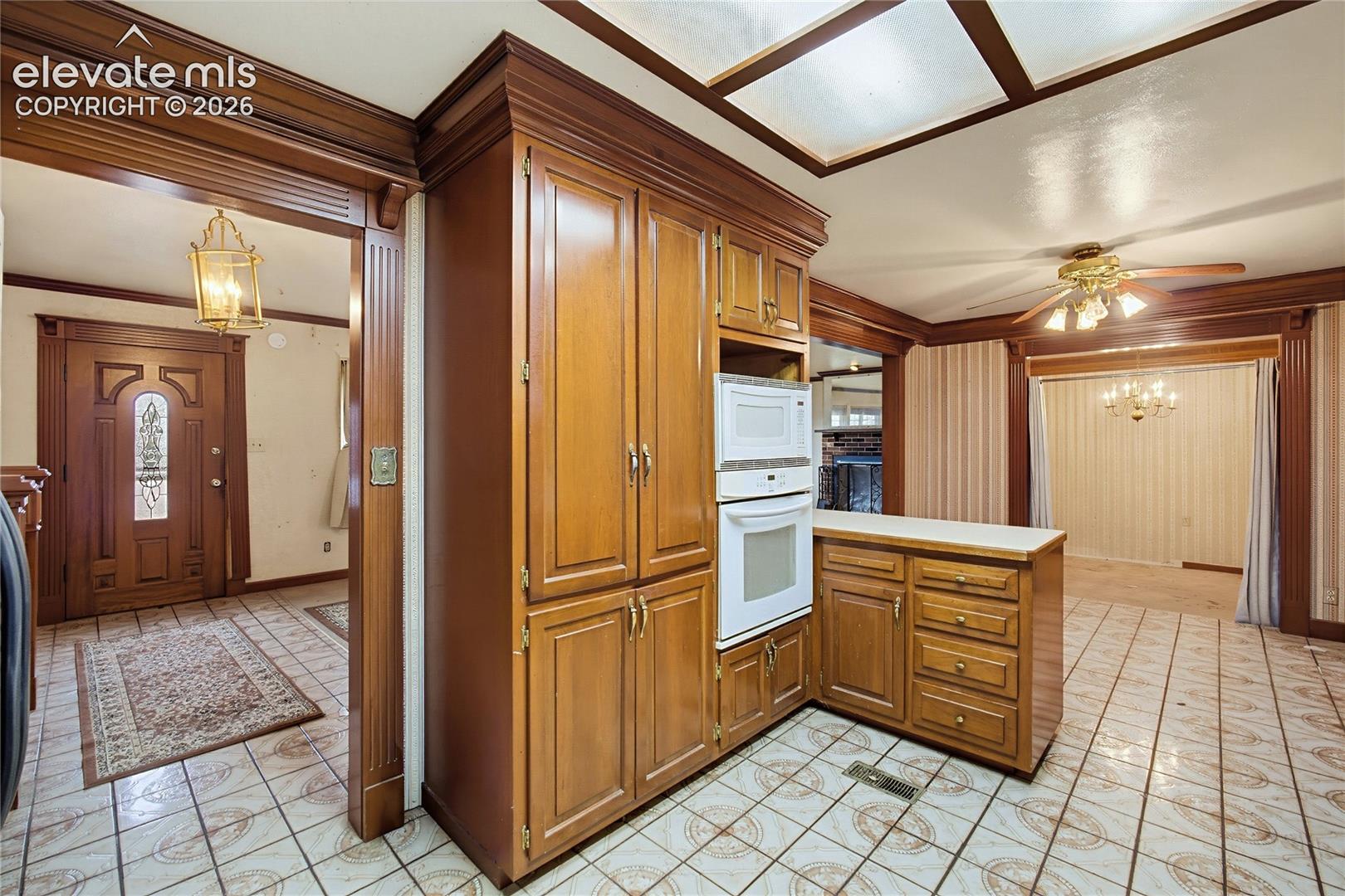 Built-in wood cabinetry with integrated microwave and oven