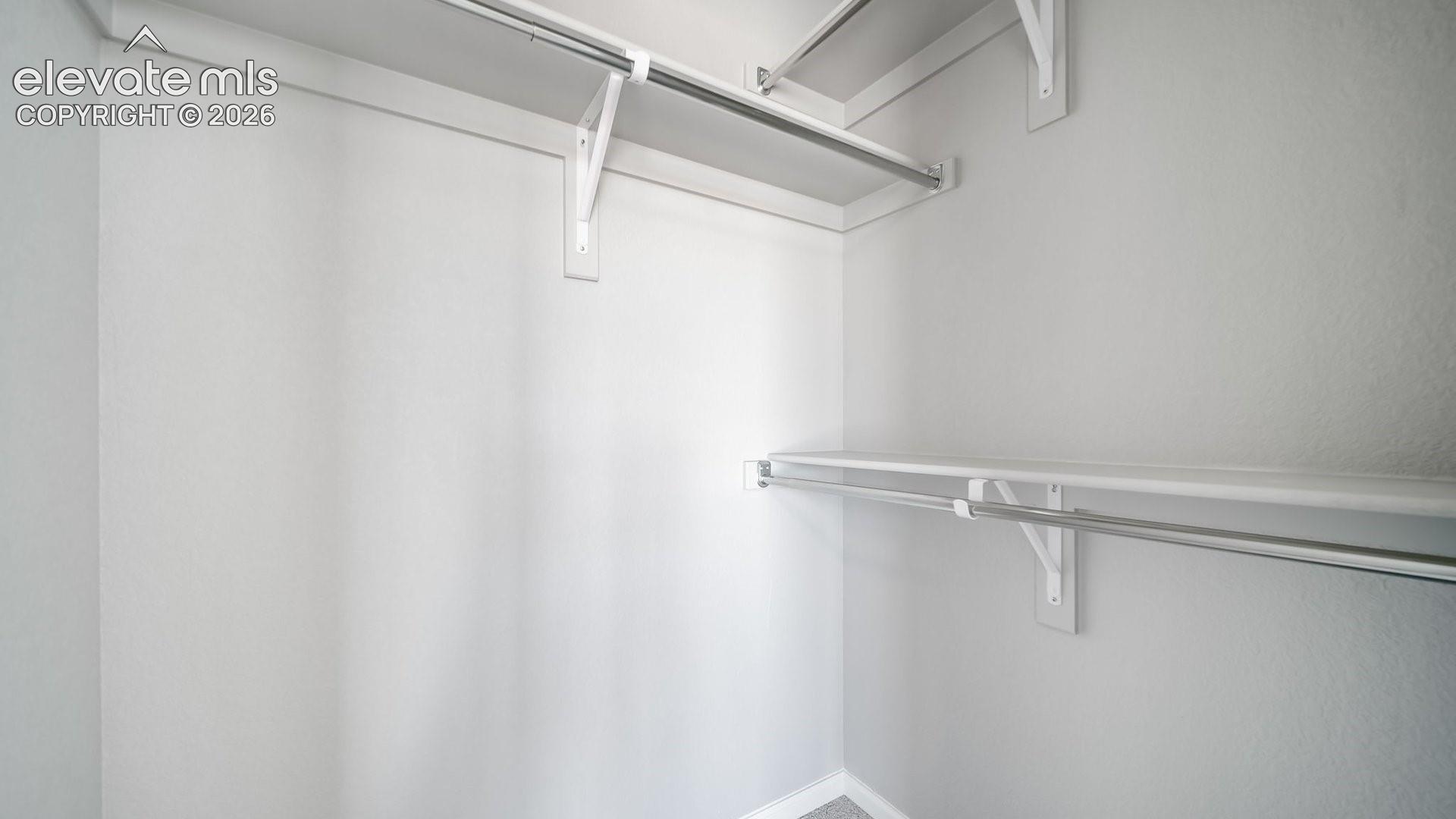 Storage area featuring dual-tier metal rods and integrated shelving units
*photos of a model home*