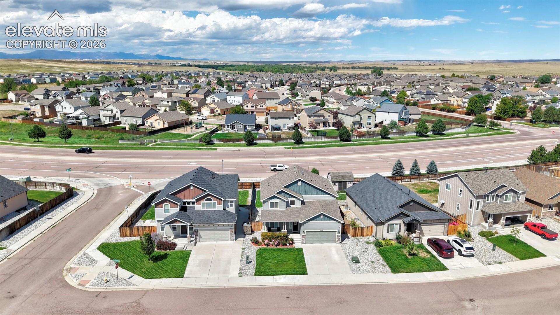 Residential neighborhood with single-family homes, paved streets, and manicured lawns