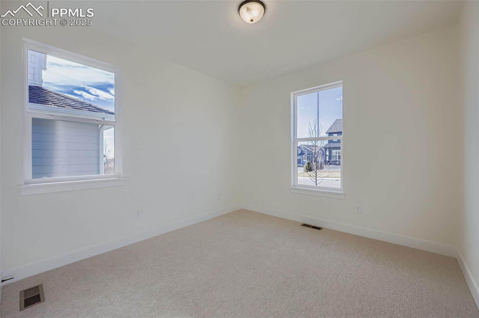 Unfurnished room with baseboards and carpet floors