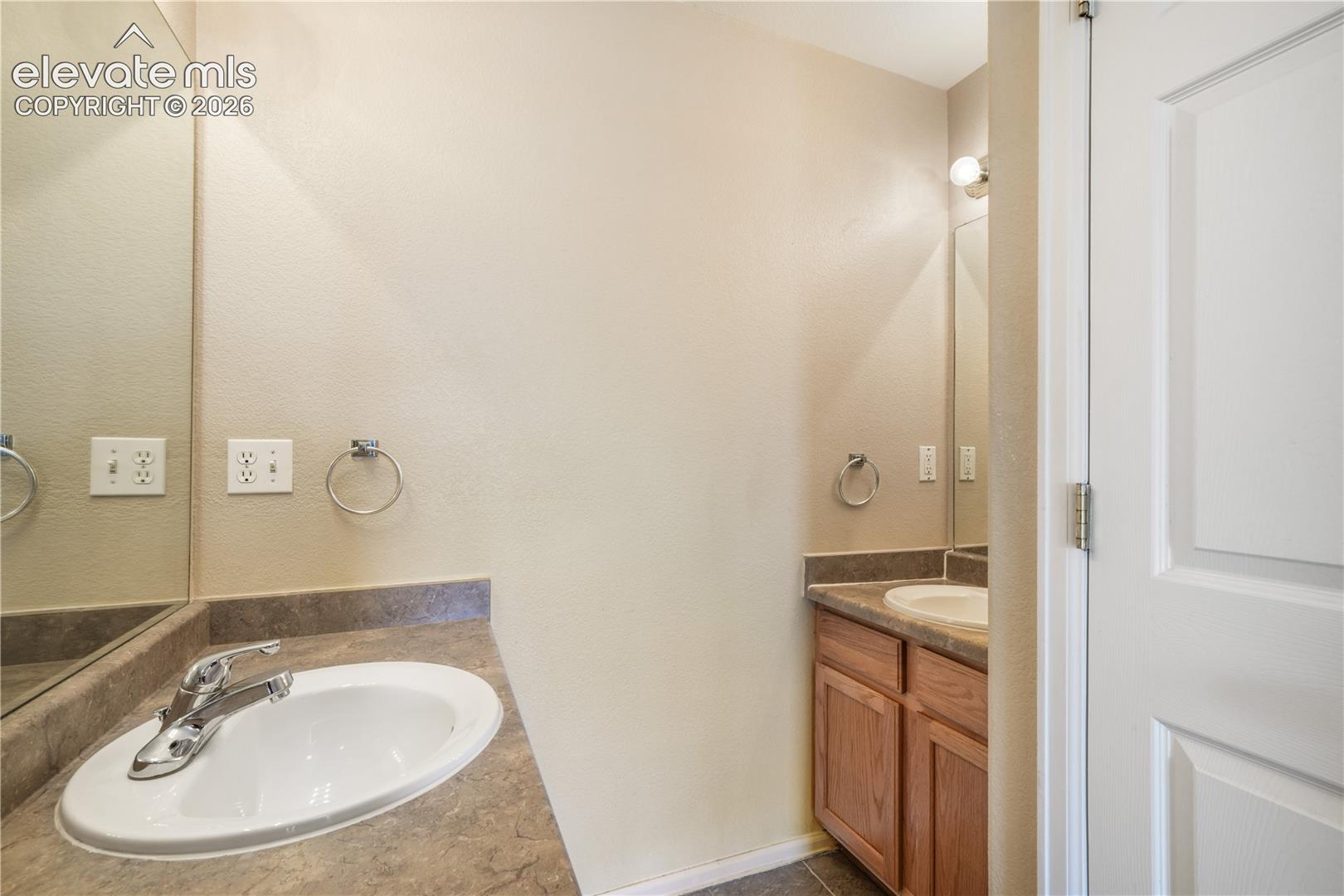 Main level primary ensuite bathroom 2 vanities, 2 separate showers