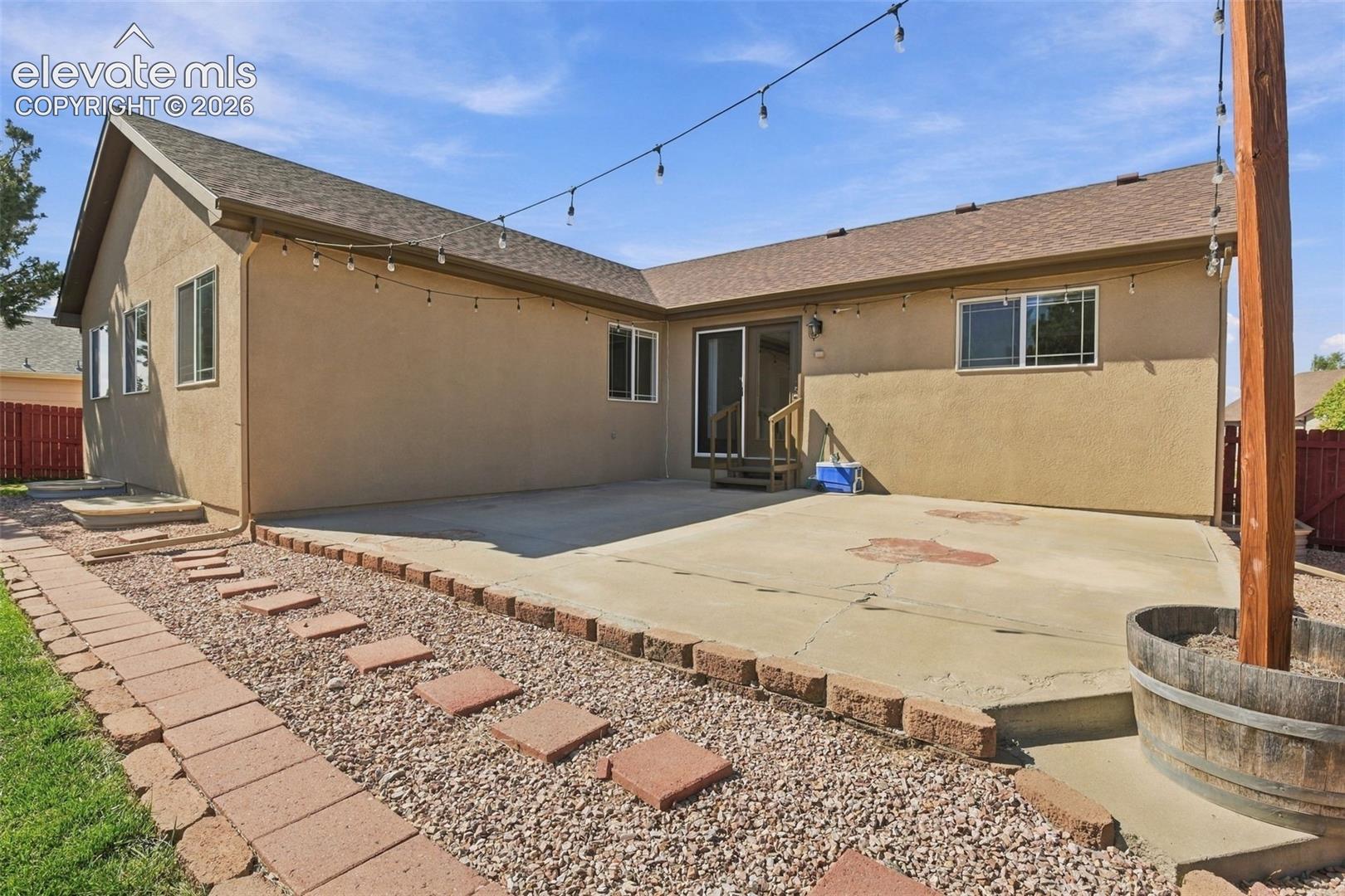 Expansive concrete patio with sliding glass door access