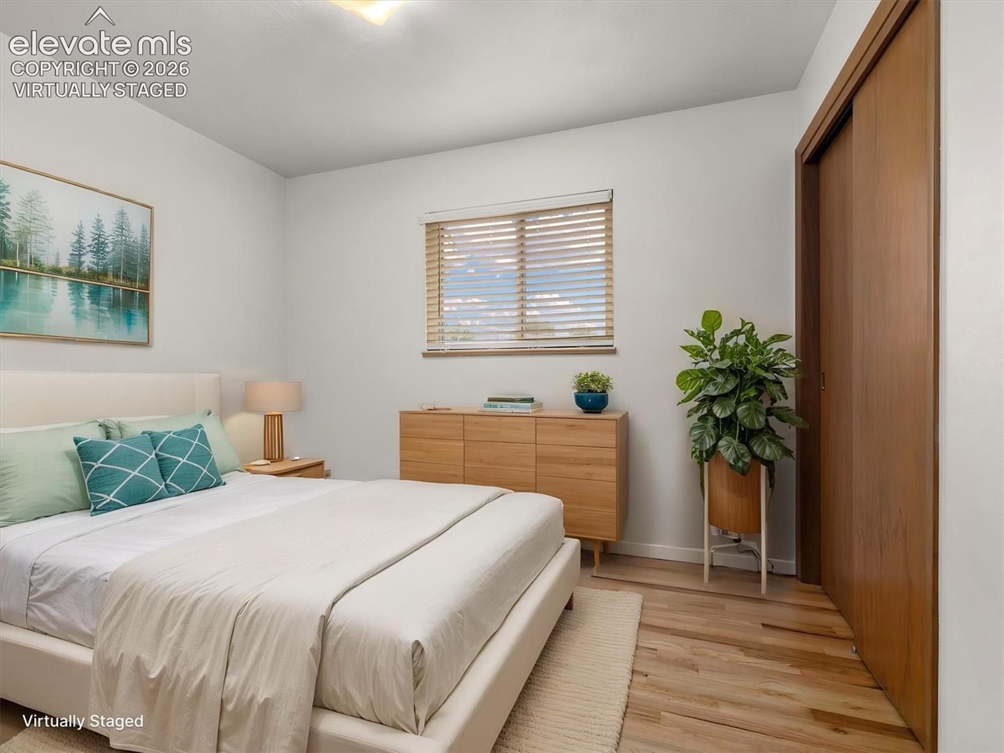 Virtually Staged, Hardwood flooring, wood-finish window blinds, and a built-in closet with sliding wood-finish doors