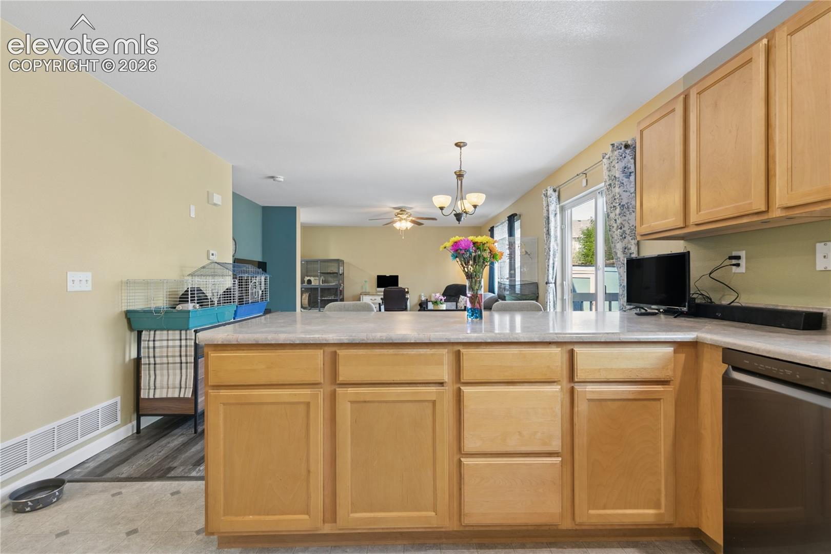 Kitchen island with light-toned cabinetry and light-colored countertops