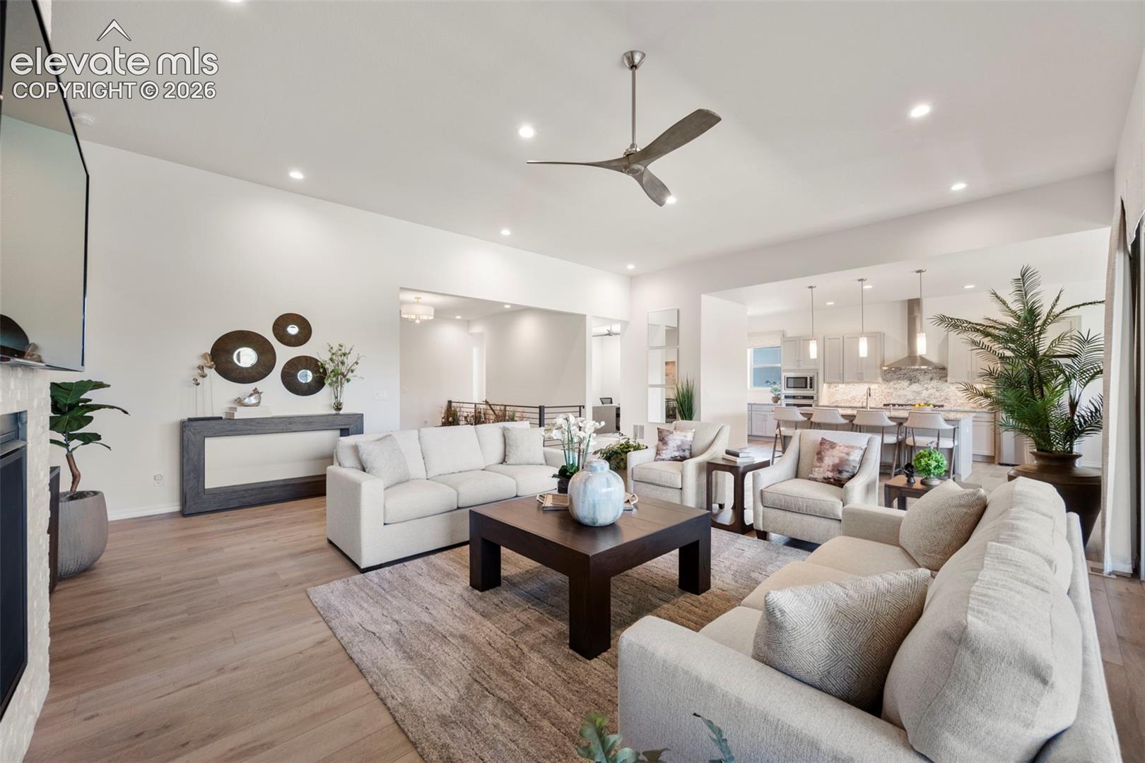 Beautiful flooring throughout, recessed lighting, and a contemporary ceiling fan