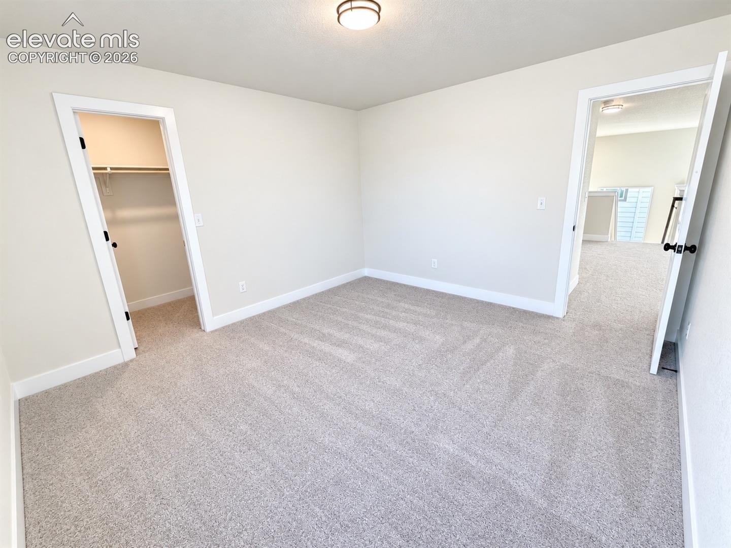 Neutral-toned wall paint and carpeting throughout the space