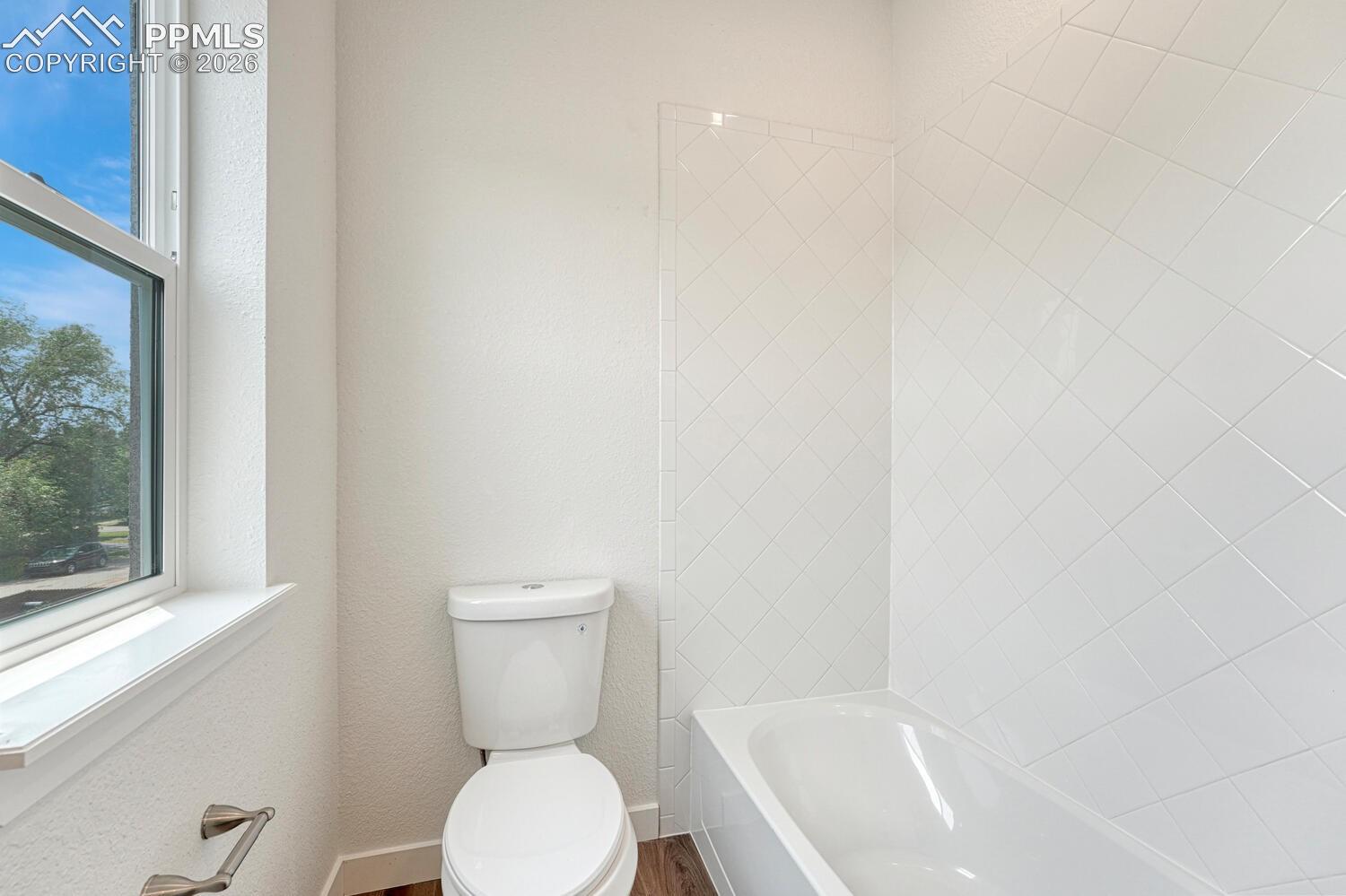 Custom tiled shower tub in the primary bathroom.