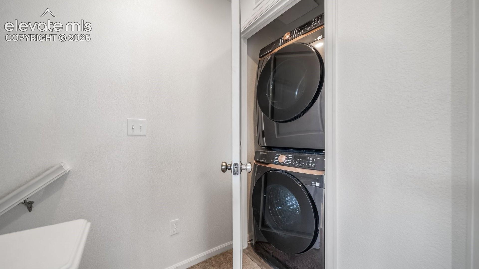 Full-size stacked washer and dryer in a dedicated closet
*photos of a model home*