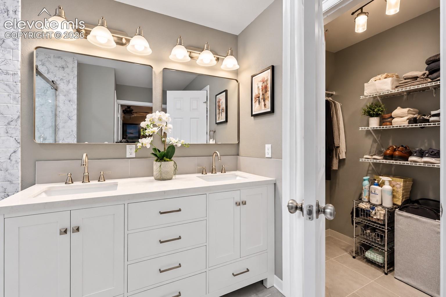 Dual sinks and generous vanity space make busy mornings easier while maintaining a clean, updated aesthetic.