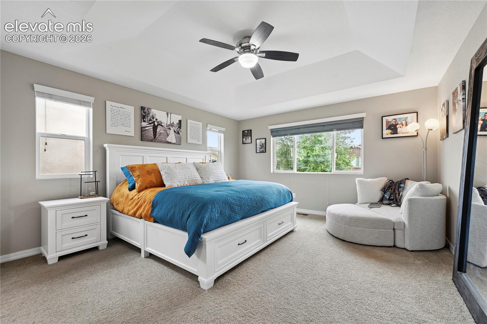 The primary suite is a lovely space with a canted tray ceiling and plenty of natural light when you want it.