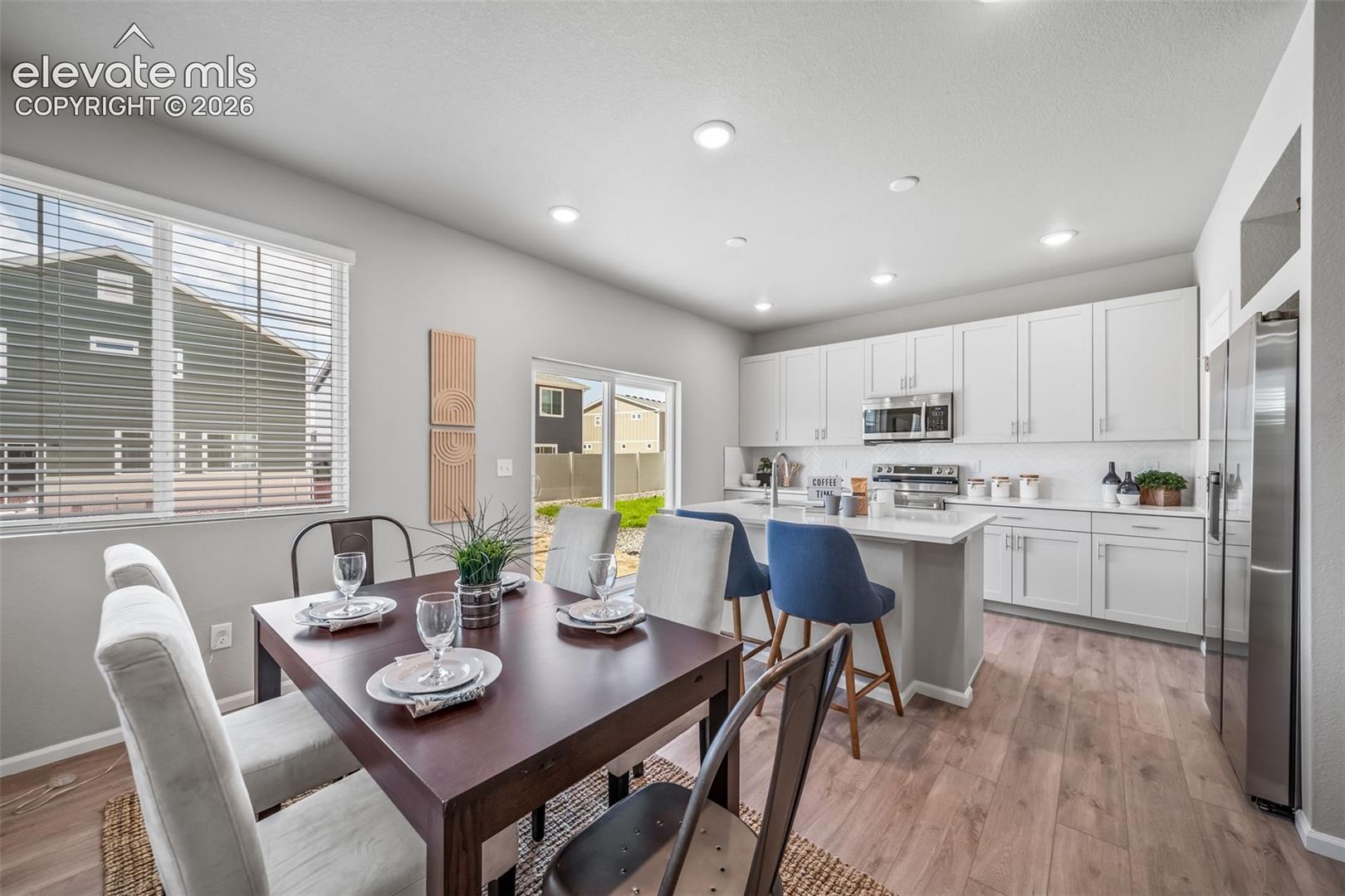 Open-concept living space with wood-finish flooring
*photos of a model home*