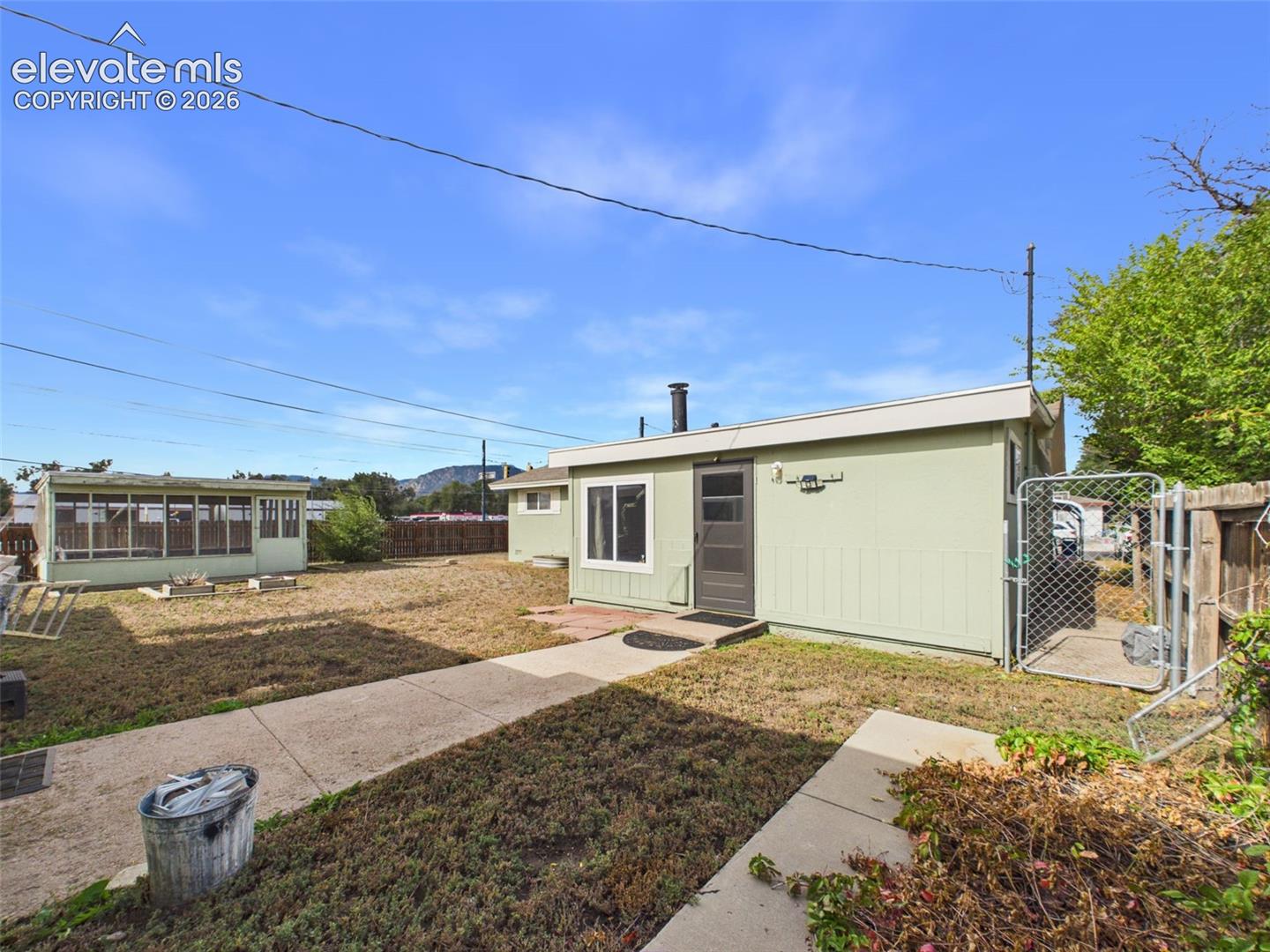 Expansive backyard featuring multiple detached outbuildings and flexible outdoor space for storage, hobbies, and gardening.