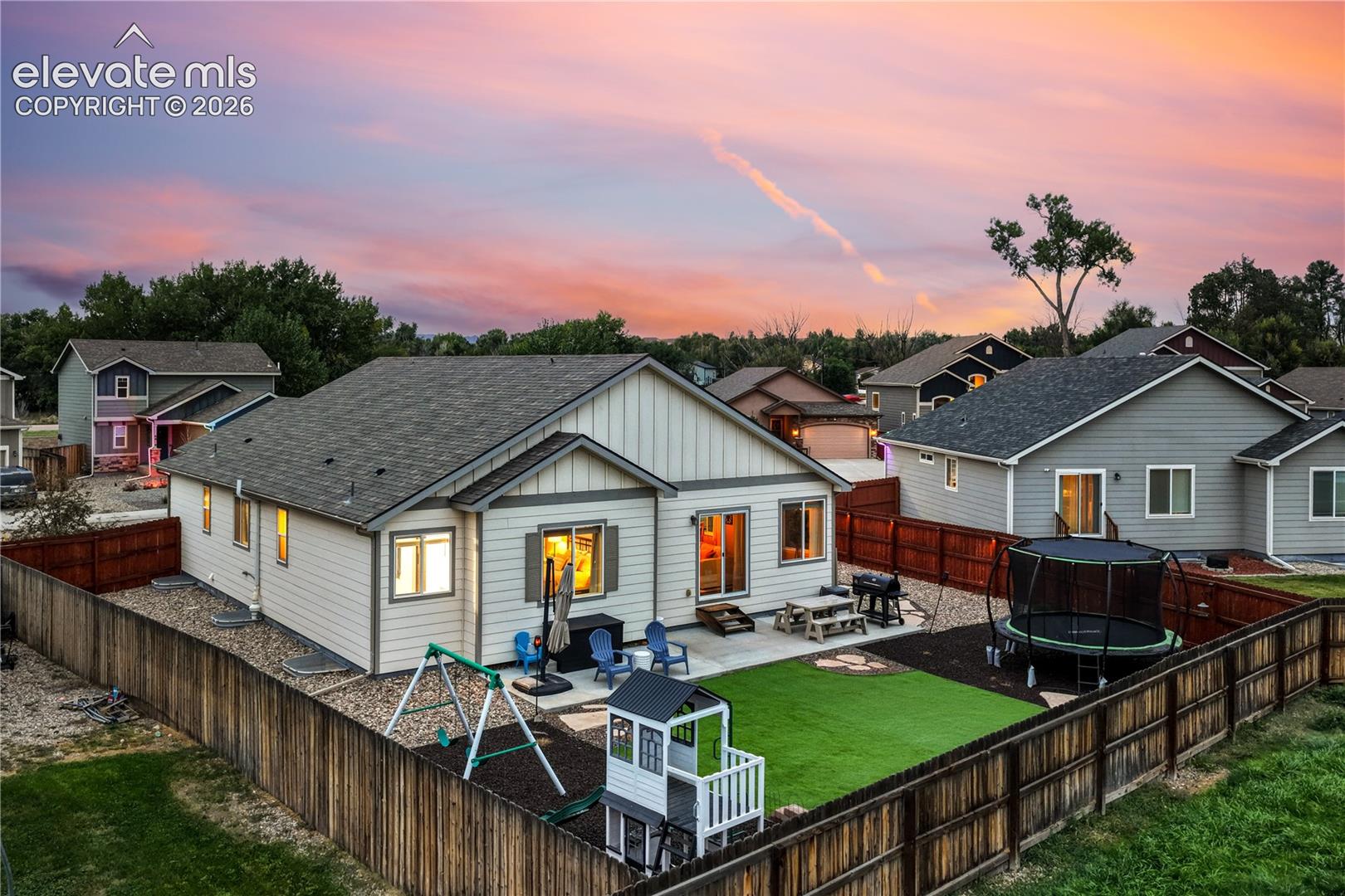 Exterior featuring a fenced backyard, an artificial turf lawn, and a concrete patio