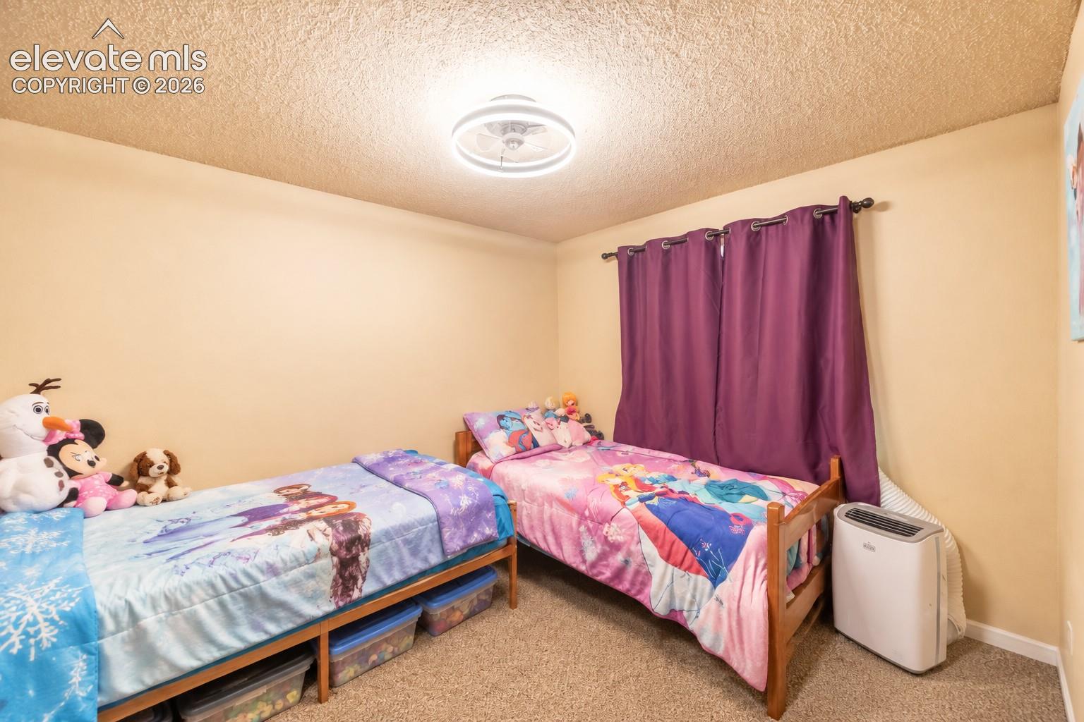 Recessed lighting fixture, textured ceiling, light-toned wall paint, and wall-to-wall carpeting