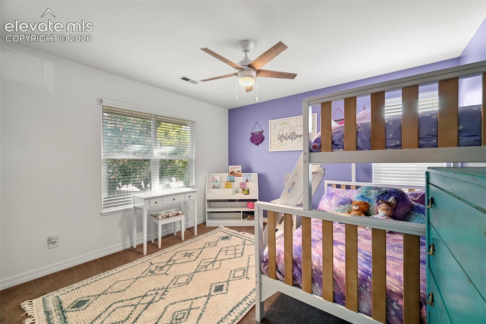 Wood-finish flooring with white baseboards, recessed lighting, and a ceiling fan