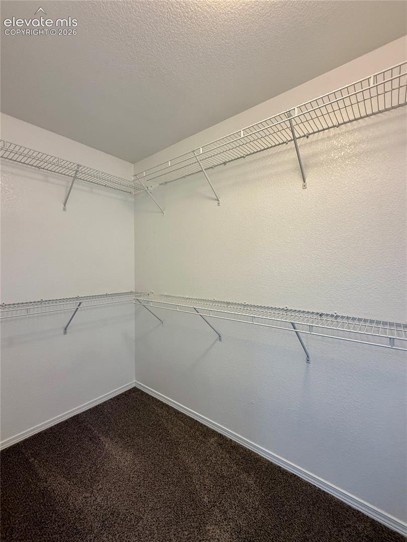 Primary bedroom walk-in closet