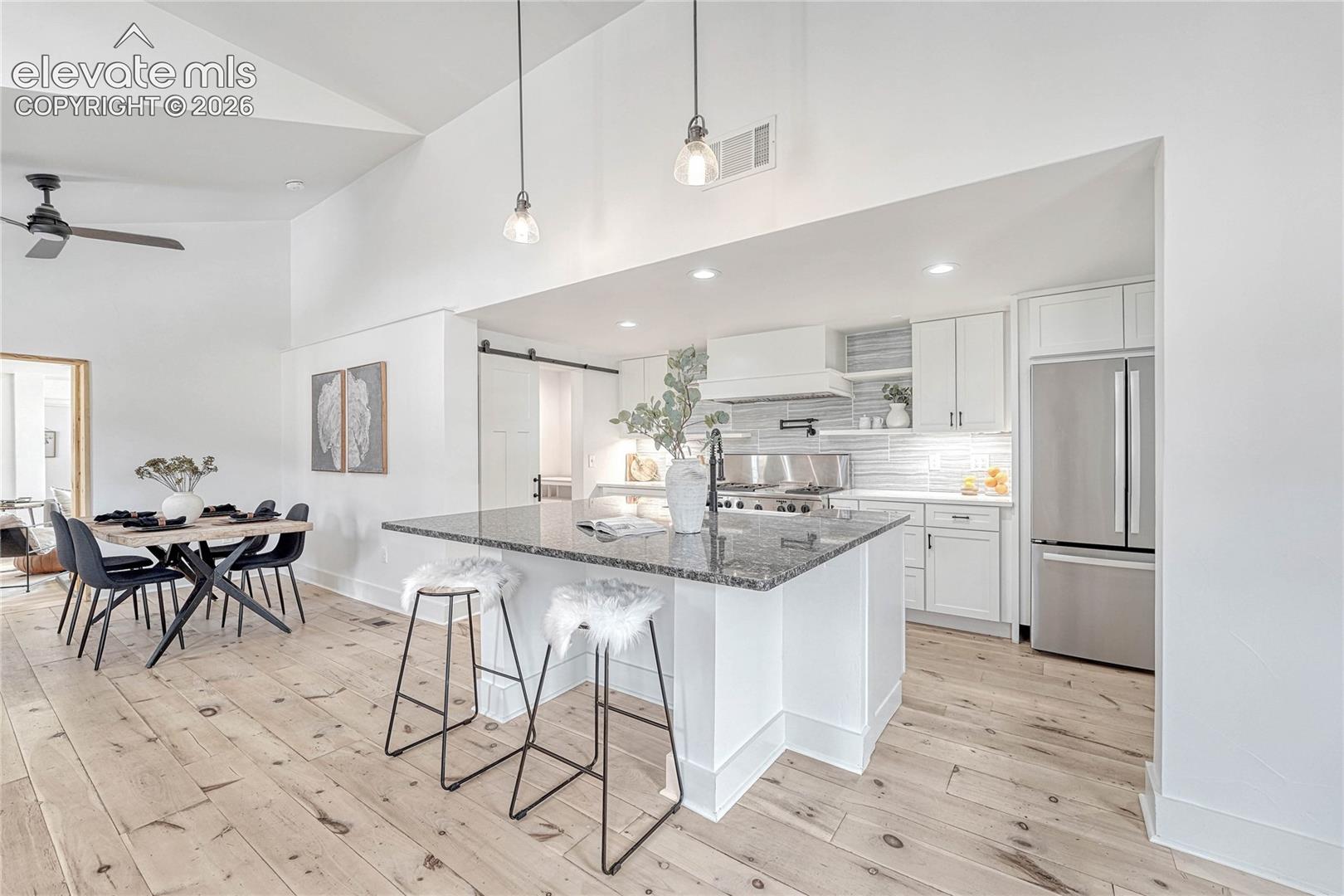 Modern Kitchen, Wood Flooring, Refrigerator, Cabinets, Ceiling Fan