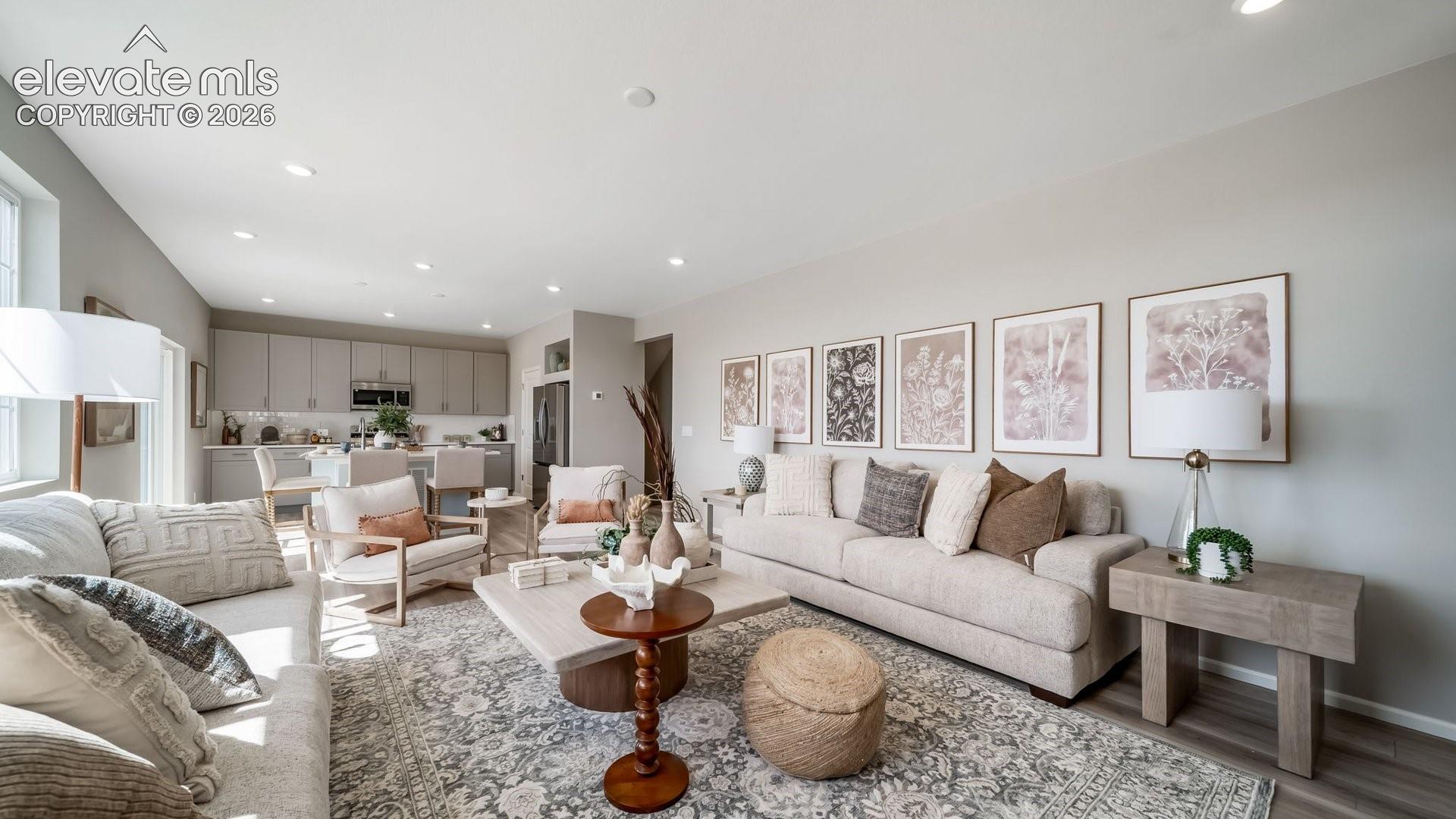 Open-concept living area featuring recessed lighting and wood-finish flooring
Photos of a model home