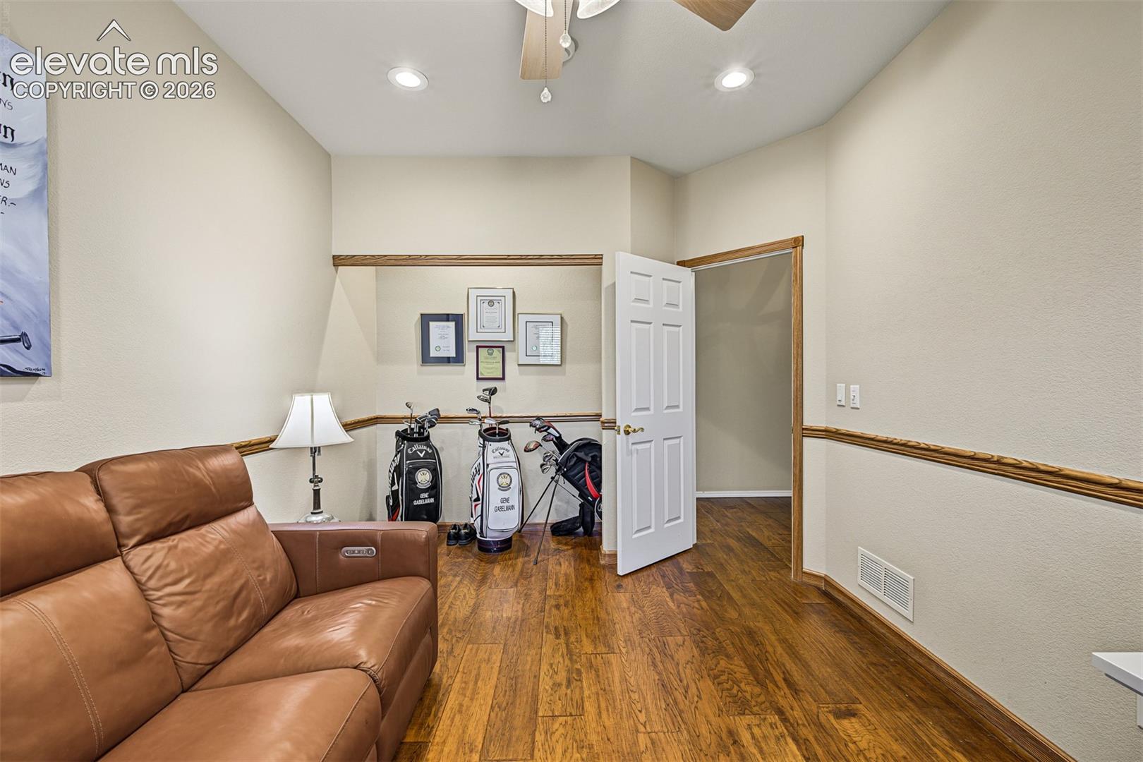 Additional main-level bedroom currently used as an office, featuring hardwood flooring, recessed lighting, ceiling fan, and an existing closet alcove.