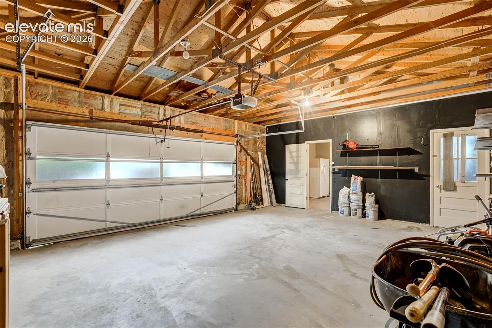 First garage leads to the oversized two car garage with door to the yard