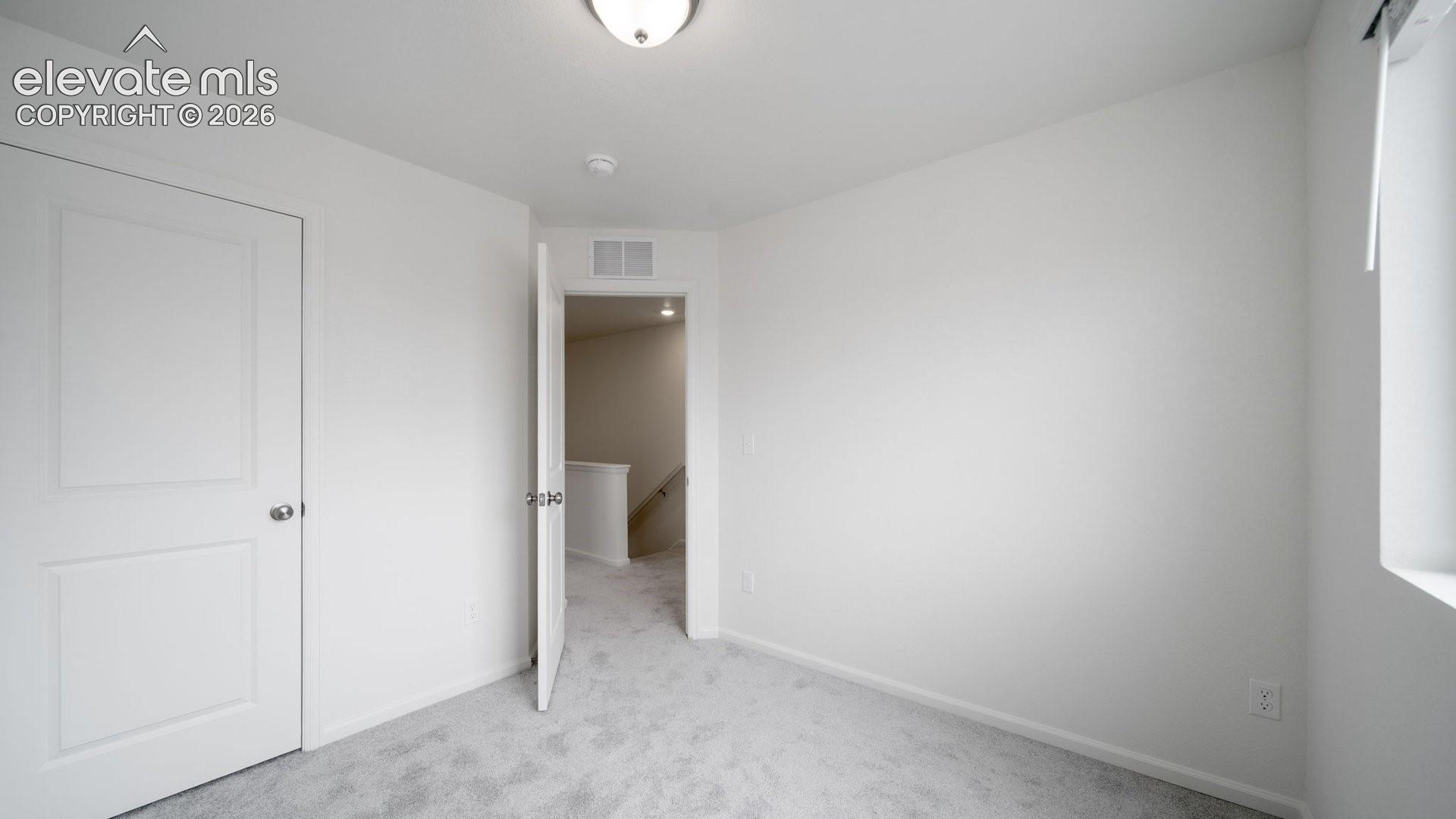 Neutral wall finishes, recessed lighting, window with blinds, and light gray carpet
*photos of a model home*