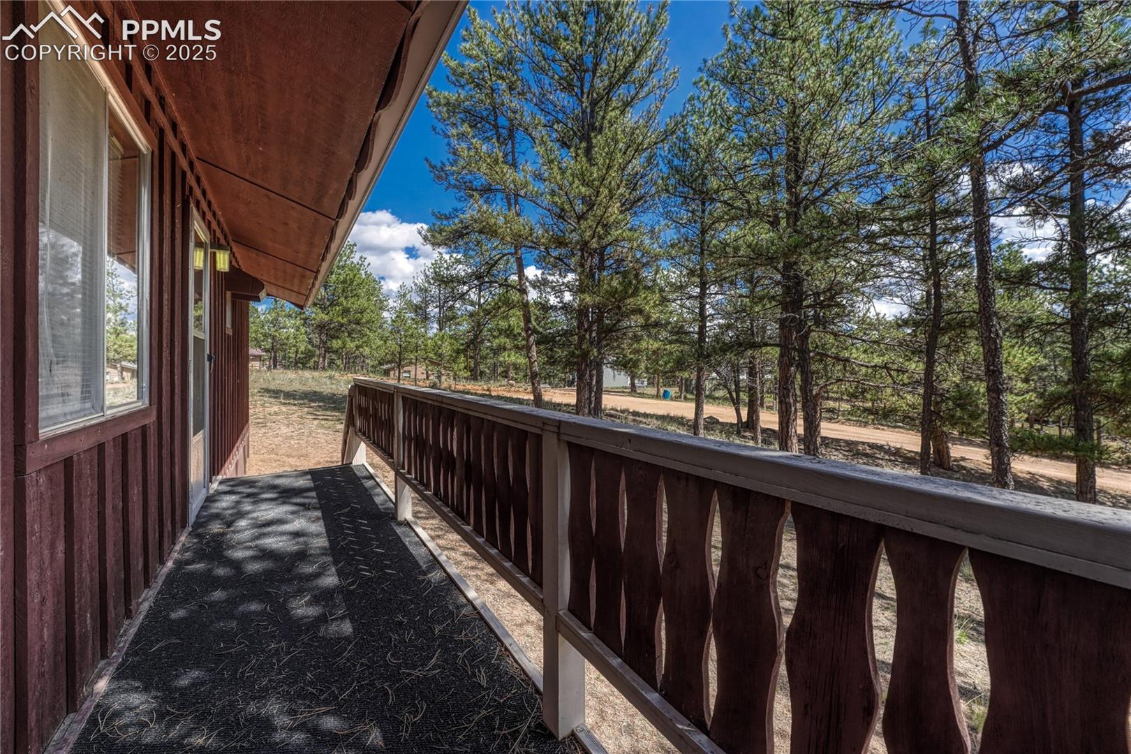 Front porch with outdoor carpeting running the length of the house
