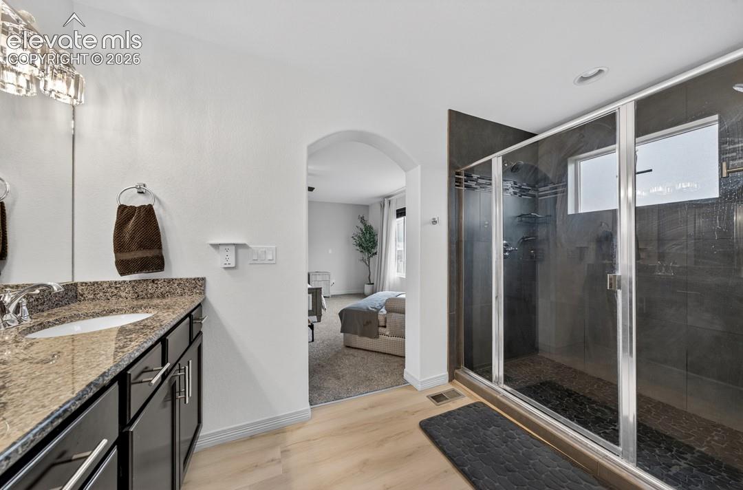 Granite, double vanity, spa shower w/ dual heads and separate controls, luxury vinyl, linen closet