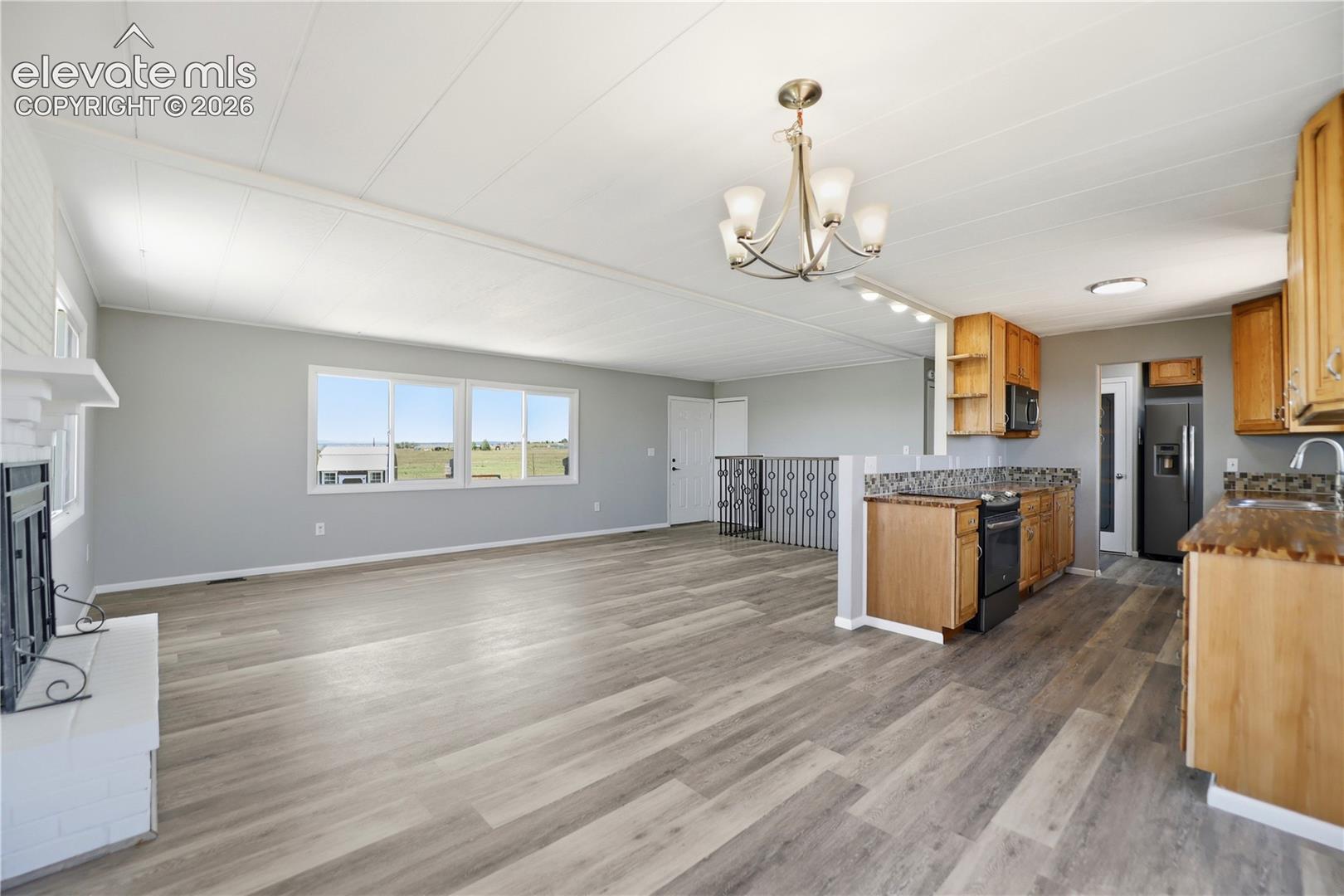 Vinyl Plank, Fireplace, Sliding Door To Deck, Dining Area