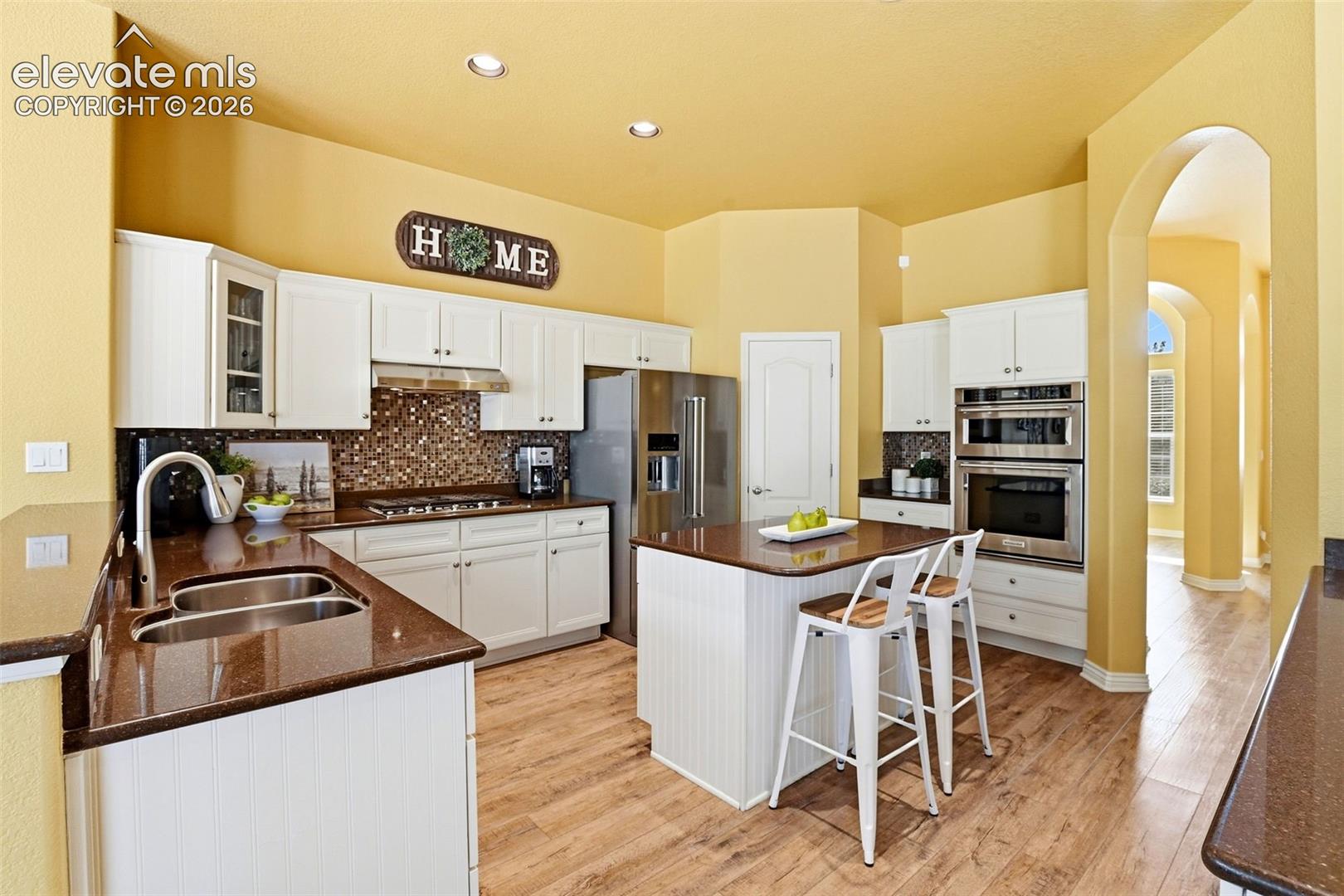 KitchenAid appliances included with gas stove, recessed lighting, mosaic tile backsplash, stainless undermount sink, and pantry. Tons of storage and everyday function. 