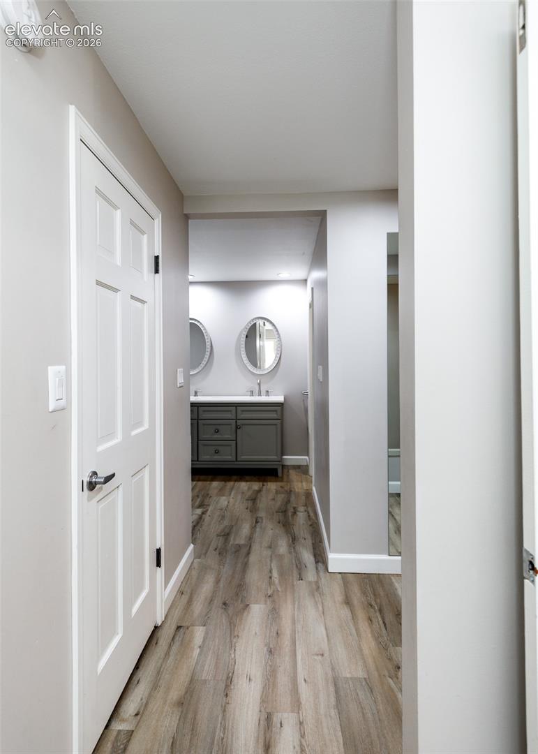 Wood-finish flooring throughout, with light gray painted walls