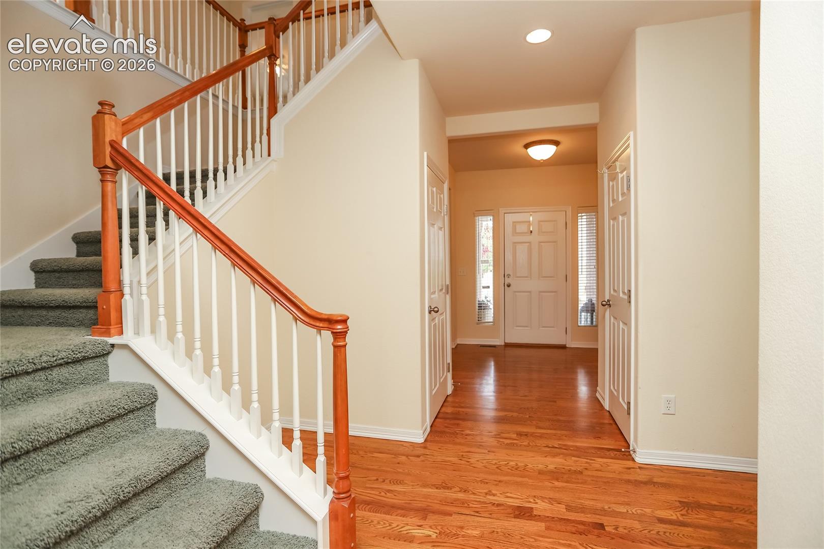 Another view of the spacious entry area featuring doors to the basement and the coat closet.