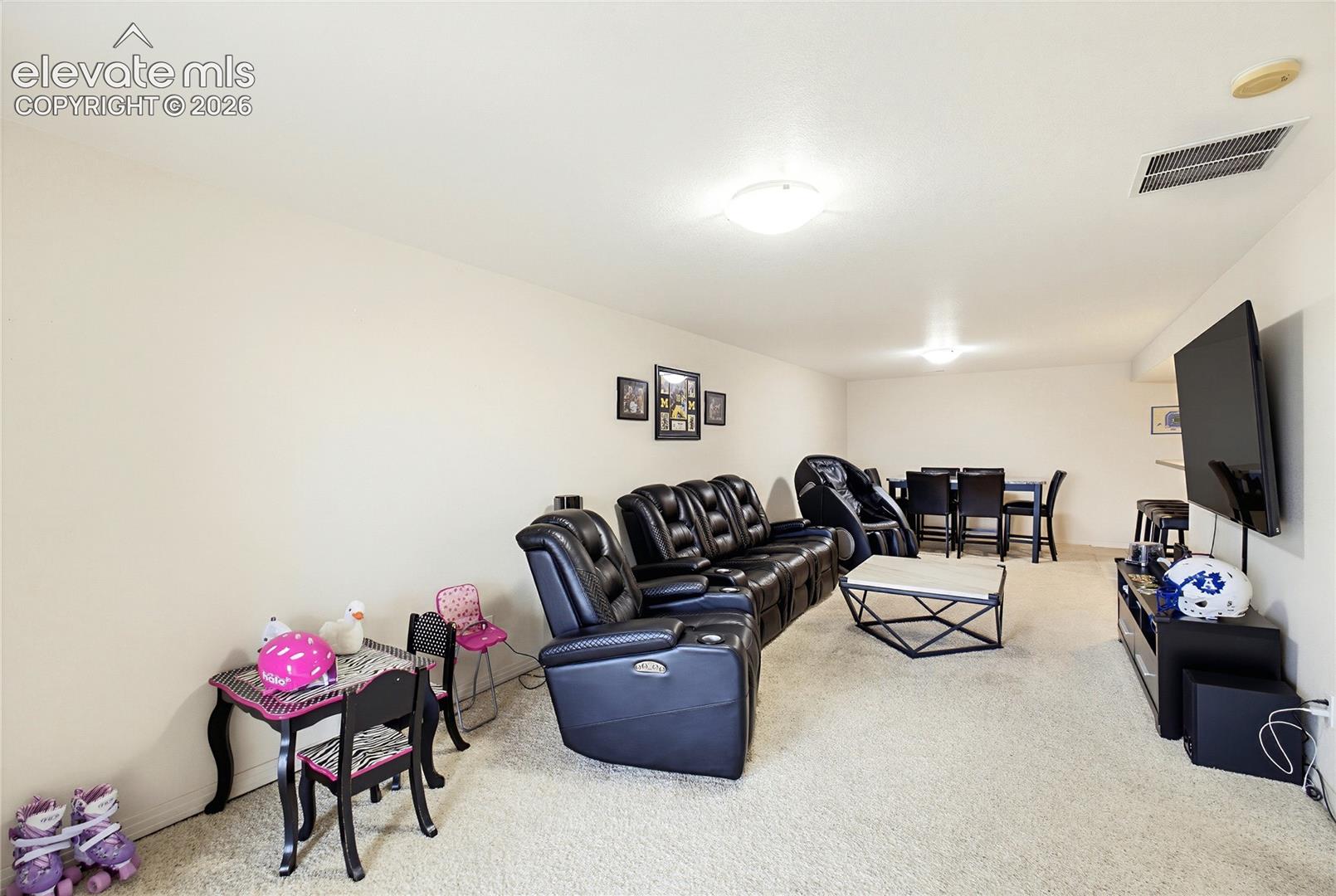 Expansive room with neutral carpeting and light-colored walls