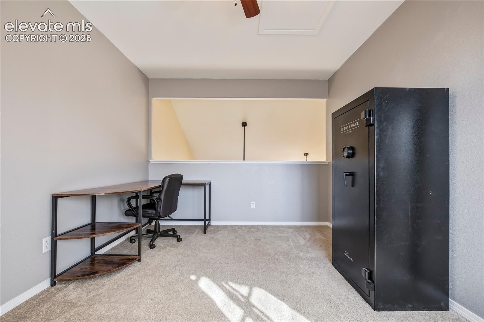 A dedicated office/sitting room off the primary suite provides a quiet place to work from home, with vaulted architectural details + separation from the main living areas.