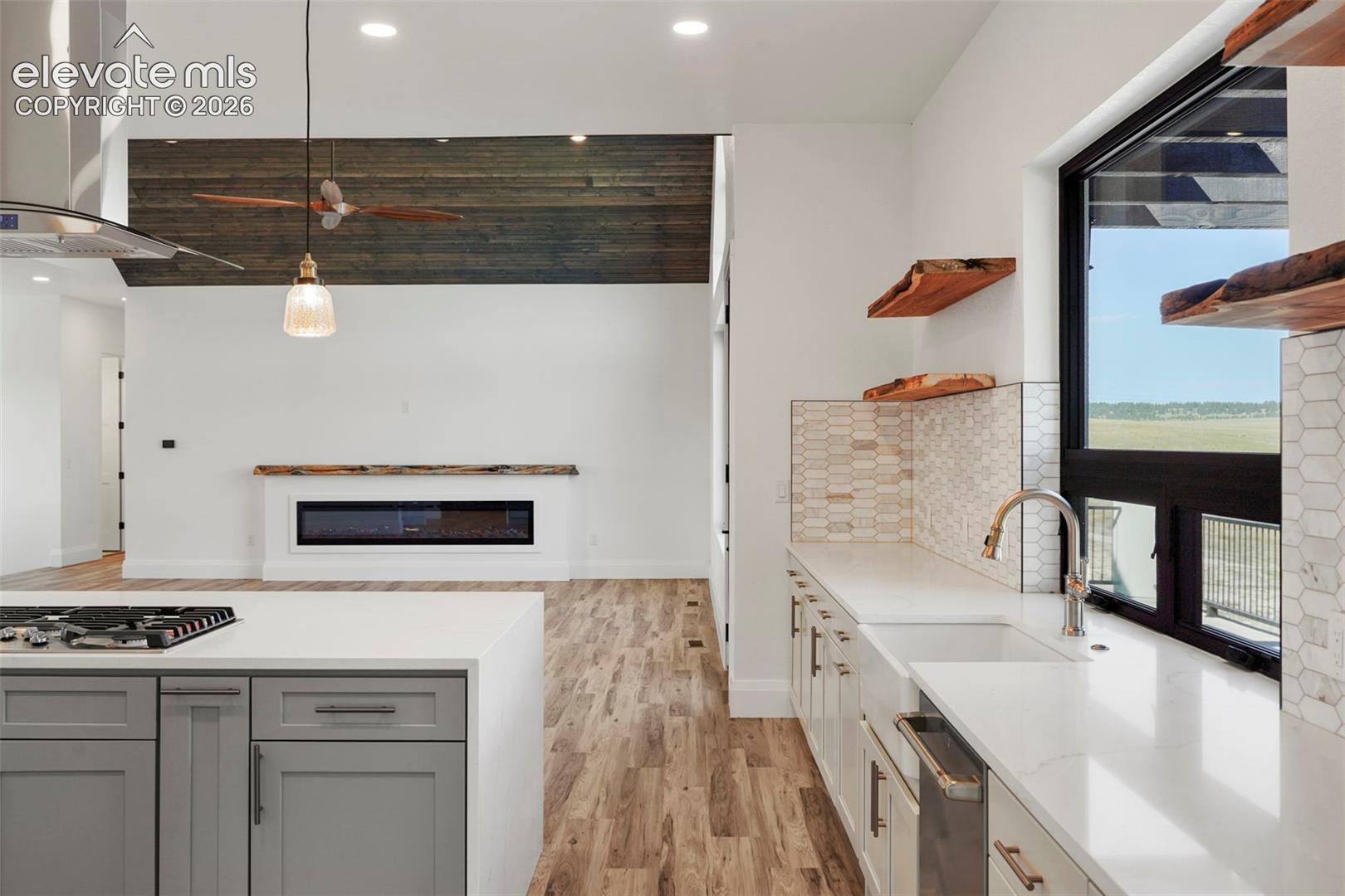 Kitchen featuring a gas range, white countertops, and gray cabinetry
