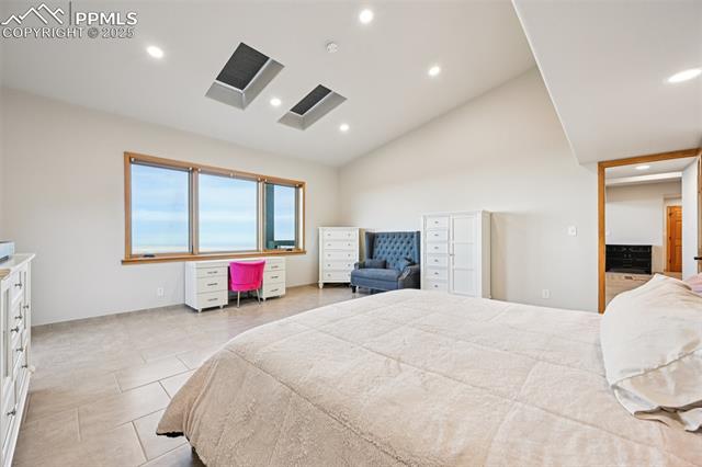 Primary bedroom with its own private walk out, en suite 5 piece bathroom, sitting area and skylights