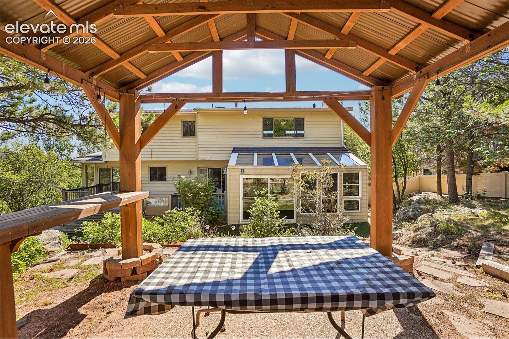 View of the house from the backyard pergola that sits atop a hill.