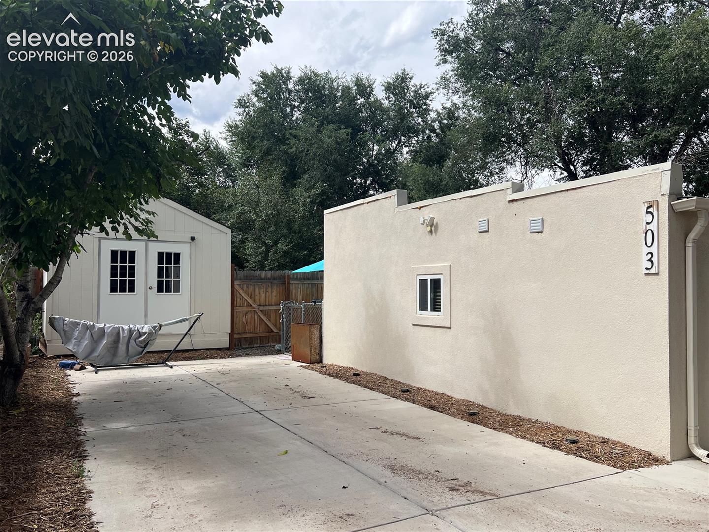 Cottage/ADU exterior with large workshop/shed and private parking