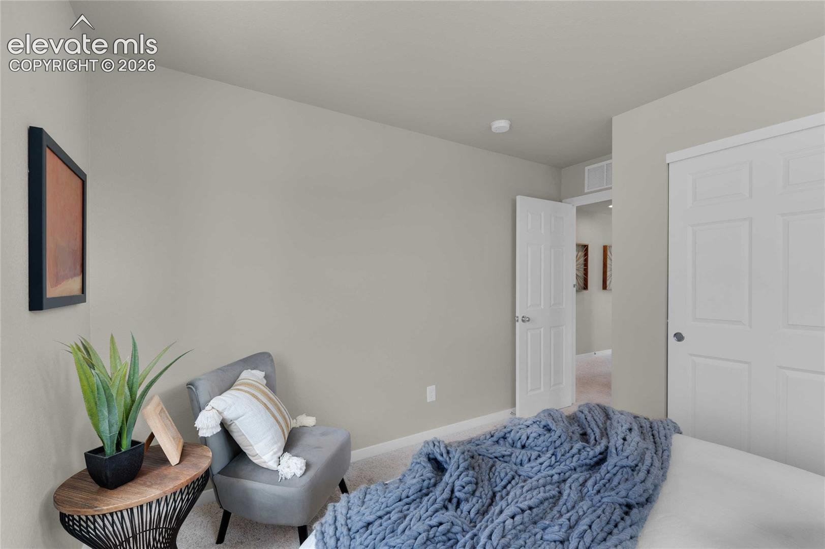 Neutral wall paint, plush carpet flooring, white paneled doors, and a built-in closet with sliding doors
*photos of a model home*