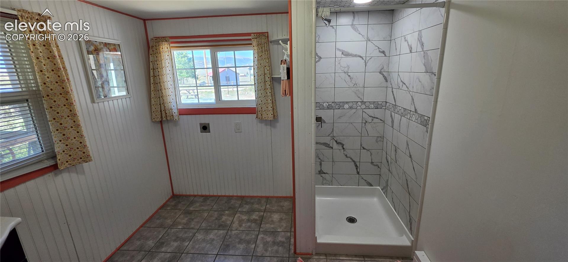 Tiled shower with a white basin